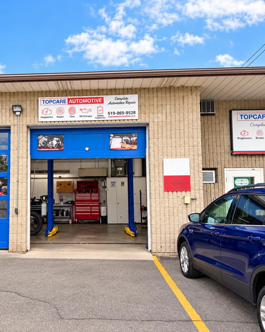 Topcare Automotive garage at 291 Rawdon Street, Brantford, with blue bay doors and an open service bay